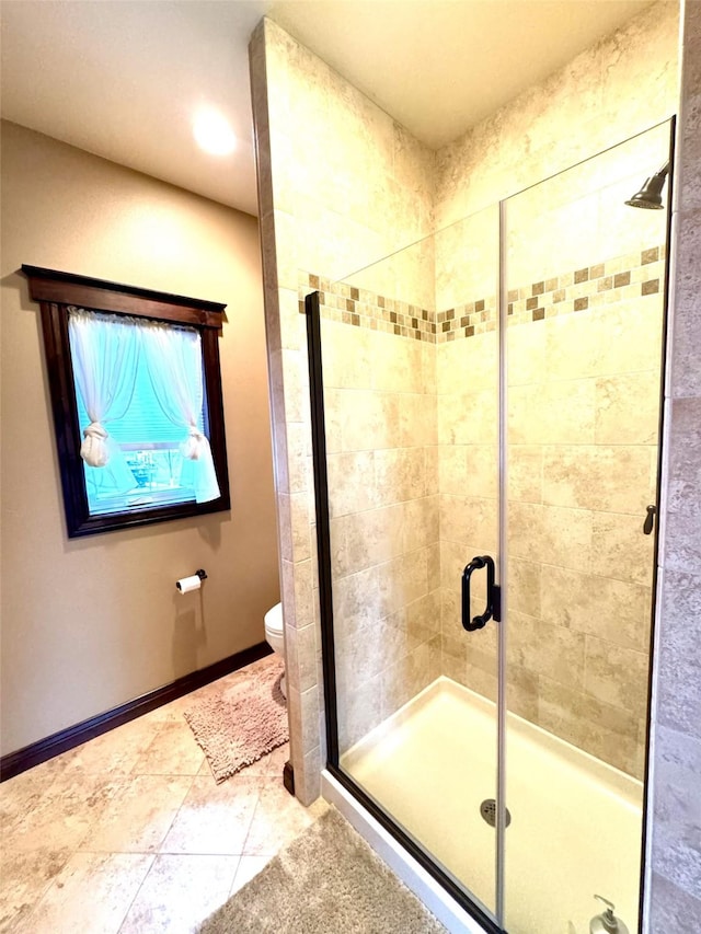 bathroom with toilet, tile patterned flooring, and a shower with door