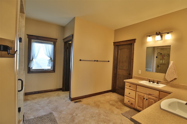 bathroom featuring vanity and a shower with door