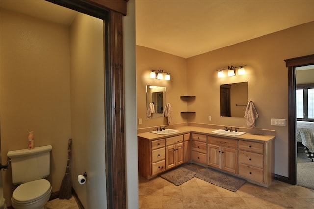 bathroom featuring toilet and vanity