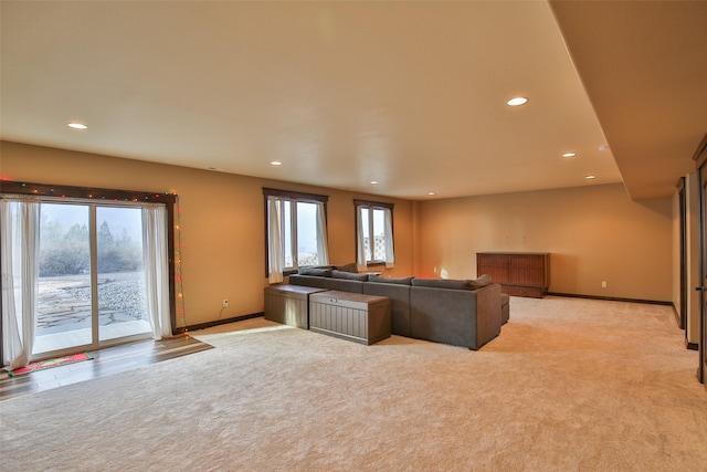 unfurnished living room featuring light colored carpet