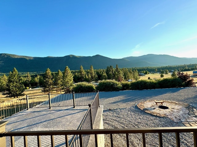 view of patio featuring a mountain view and a fire pit