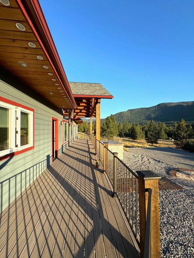 wooden deck with a mountain view