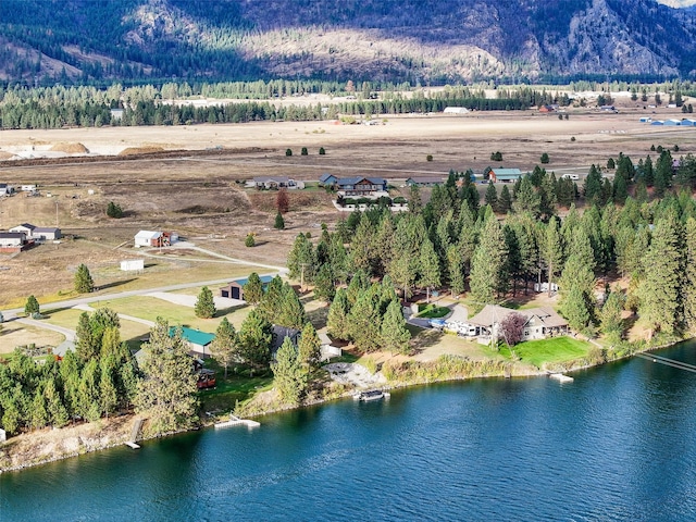 drone / aerial view featuring a water and mountain view