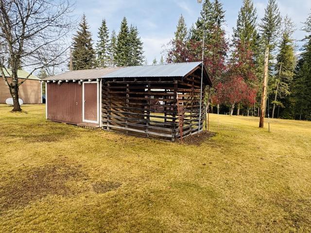 view of outbuilding with a lawn