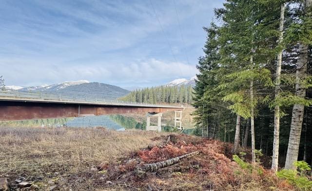 view of home's exterior with a water and mountain view