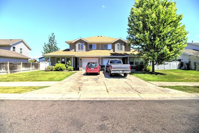 view of front of house featuring a garage and a front lawn