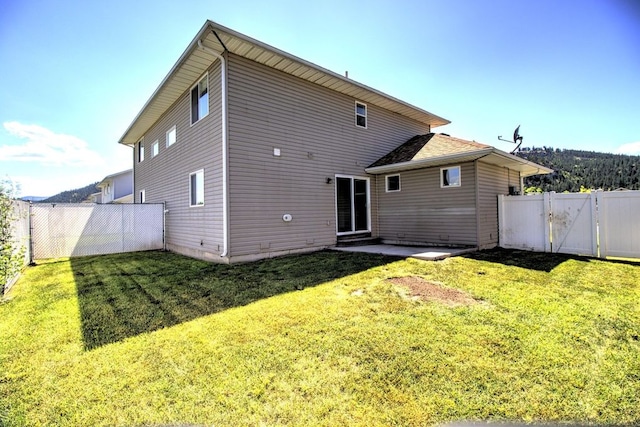 7AND9 Stratford Dr, Kalispell, MT 59901 - back of property featuring a lawn and a patio area