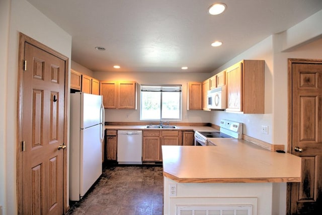7AND9 Stratford Dr, Kalispell, MT 59901 - kitchen with kitchen peninsula, light brown cabinets, white appliances, and sink