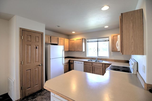 7AND9 Stratford Dr, Kalispell, MT 59901 - kitchen with light brown cabinets, sink, white appliances, and kitchen peninsula