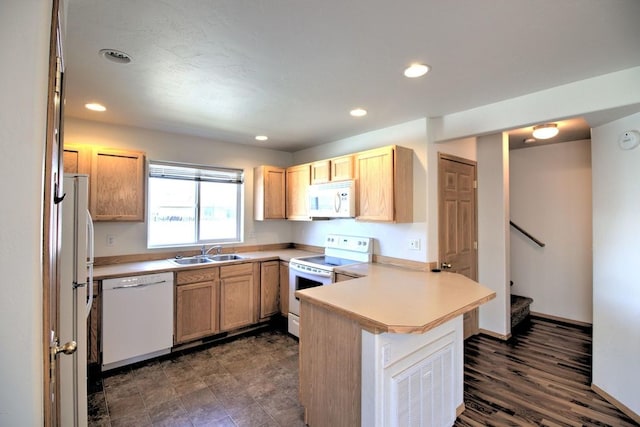 7AND9 Stratford Dr, Kalispell, MT 59901 - kitchen with white appliances, a kitchen breakfast bar, sink, dark hardwood / wood-style flooring, and kitchen peninsula