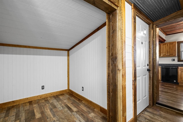 additional living space featuring dark hardwood / wood-style flooring and wooden walls