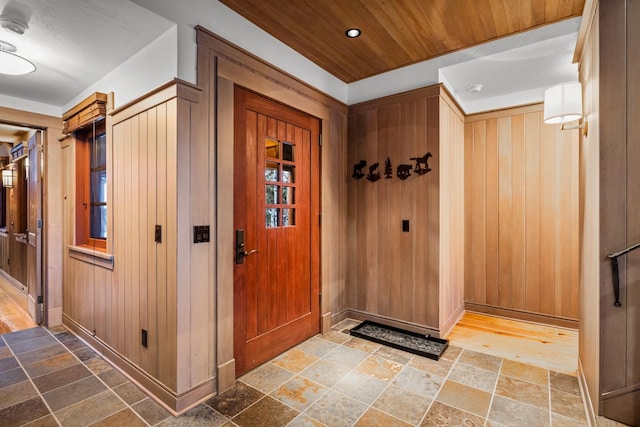 2120 Iron Horse Dr Unit 11, Whitefish, MT 59937 - entrance foyer featuring stone tile floors, baseboards, and wooden walls
