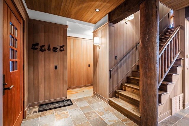 2120 Iron Horse Dr Unit 11, Whitefish, MT 59937 - stairs with stone finish floors, wood walls, baseboards, and wood ceiling