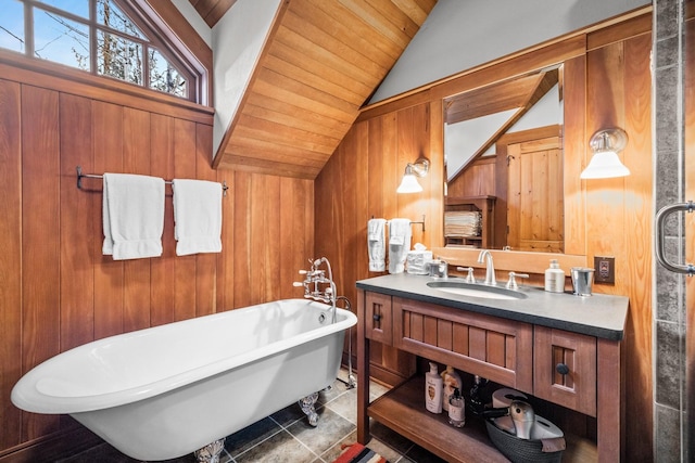 2120 Iron Horse Dr Unit 11, Whitefish, MT 59937 - full bathroom featuring lofted ceiling, a freestanding bath, wood walls, vanity, and wood ceiling