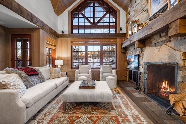 2120 Iron Horse Dr Unit 11, Whitefish, MT 59937 - living room featuring a stone fireplace, plenty of natural light, high vaulted ceiling, stone tile floors, and wood ceiling