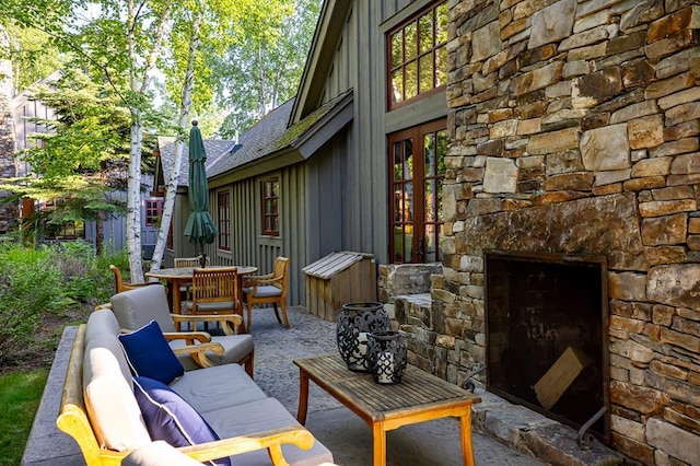 2120 Iron Horse Dr Unit 11, Whitefish, MT 59937 - view of patio featuring an outdoor living space with a fireplace and outdoor dining area