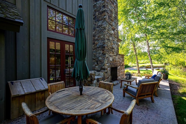 2120 Iron Horse Dr Unit 11, Whitefish, MT 59937 - view of patio / terrace with an outdoor stone fireplace and outdoor dining space