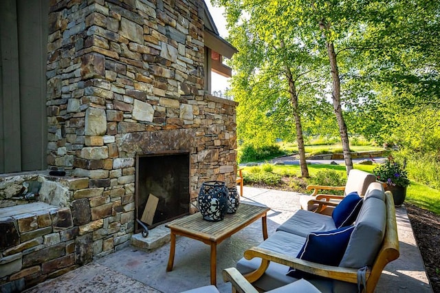 2120 Iron Horse Dr Unit 11, Whitefish, MT 59937 - view of patio / terrace featuring an outdoor stone fireplace