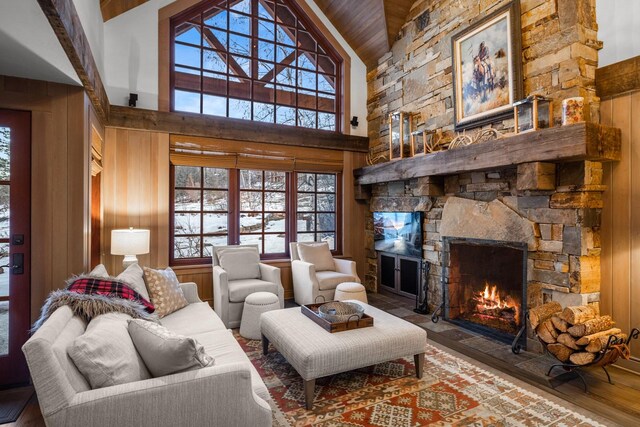 2120 Iron Horse Dr Unit 11, Whitefish, MT 59937 - living area with a stone fireplace, plenty of natural light, wood finished floors, high vaulted ceiling, and wood walls
