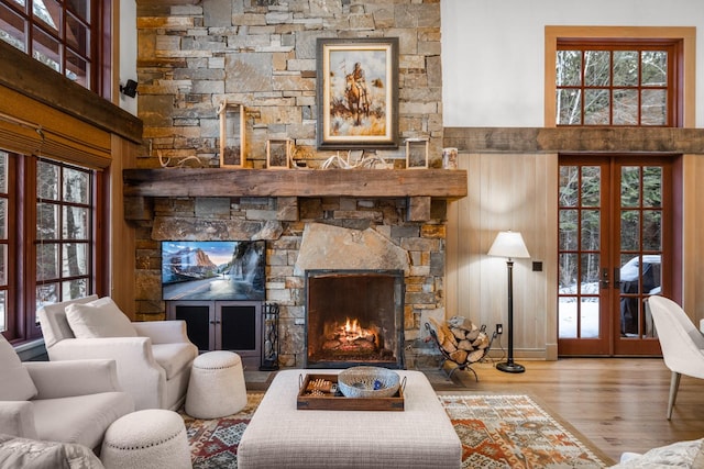 2120 Iron Horse Dr Unit 11, Whitefish, MT 59937 - living room with wood finished floors, french doors, a fireplace, and healthy amount of natural light
