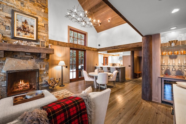 living room featuring a fireplace, wood-type flooring, and high vaulted ceiling