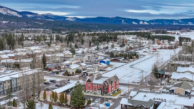 snowy aerial view with a mountain view