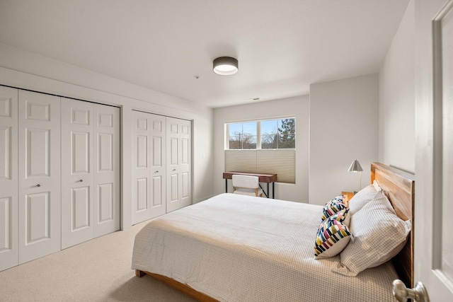 carpeted bedroom with multiple closets