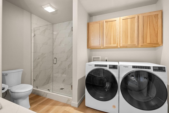 washroom featuring independent washer and dryer and light hardwood / wood-style flooring