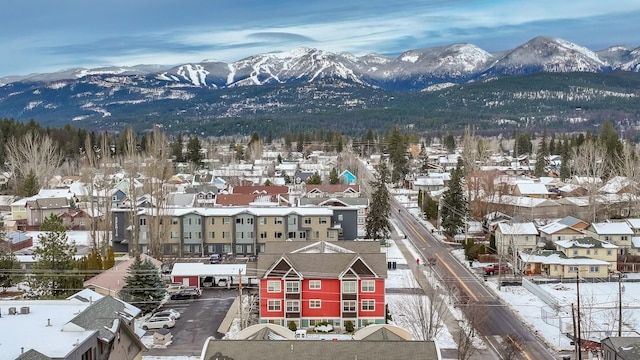 snowy aerial view with a mountain view