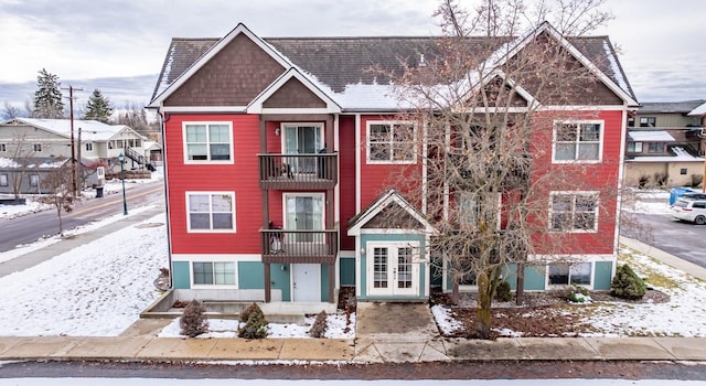 view of front of home featuring a balcony and french doors