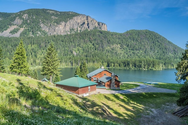 exterior space featuring a yard and a water and mountain view