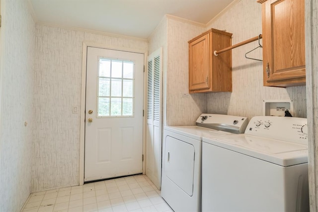 laundry room with cabinets, washer and dryer, and ornamental molding