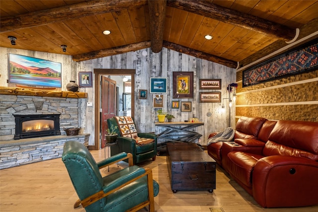 interior space with a stone fireplace, wood ceiling, and light hardwood / wood-style flooring