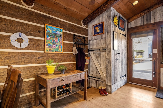 interior space with wood walls, hardwood / wood-style floors, and wooden ceiling