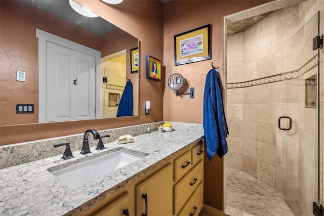 bathroom featuring vanity and a shower with shower door