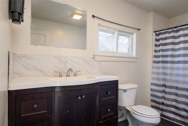 bathroom featuring decorative backsplash, toilet, and vanity