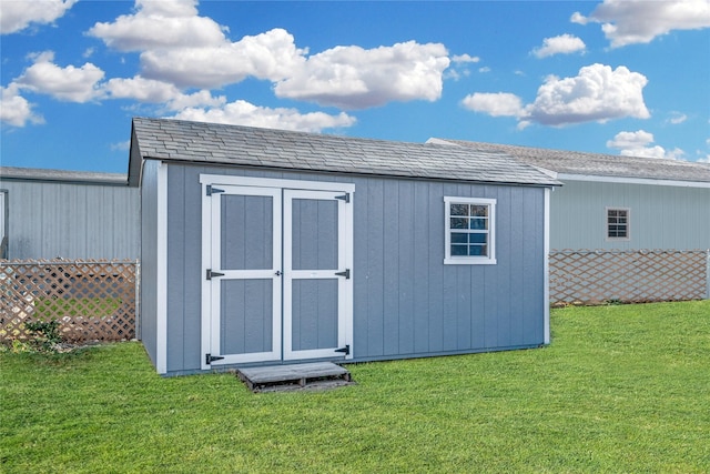 view of outdoor structure featuring a lawn