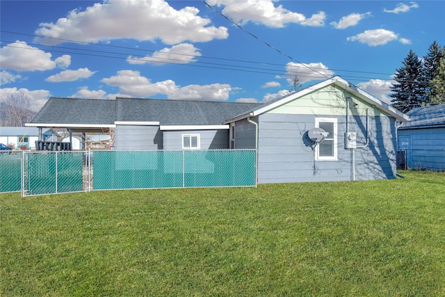 rear view of property with a yard