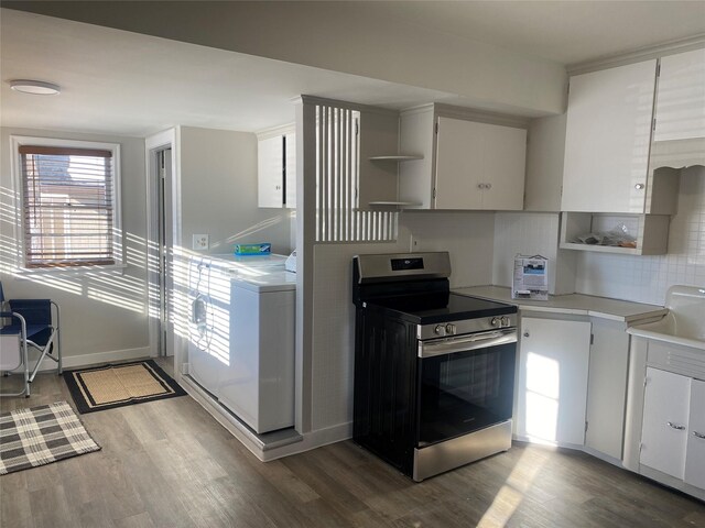 clothes washing area featuring dark hardwood / wood-style floors and washer and clothes dryer