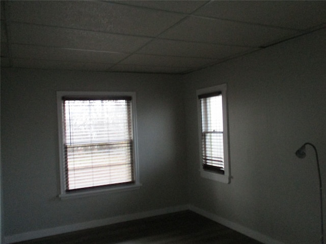 unfurnished room with a drop ceiling