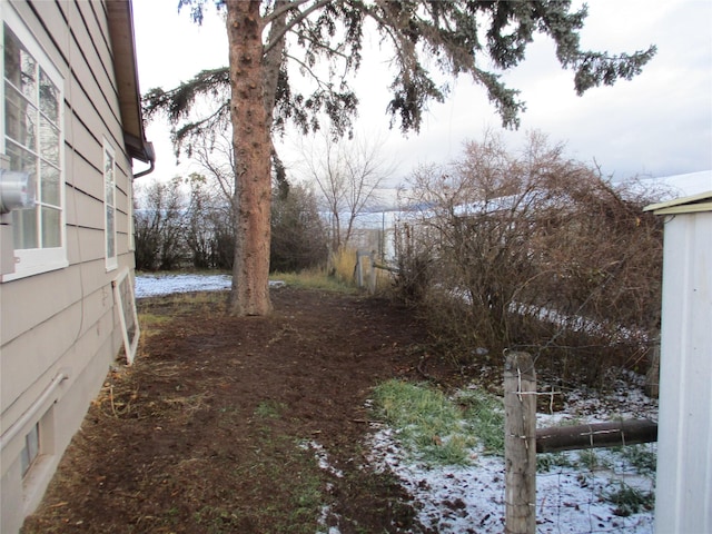 view of yard layered in snow