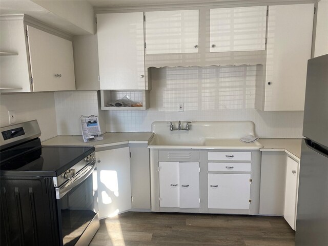 kitchen featuring electric range and white cabinets