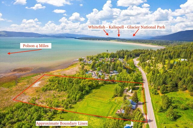 birds eye view of property featuring a mountain view and a rural view