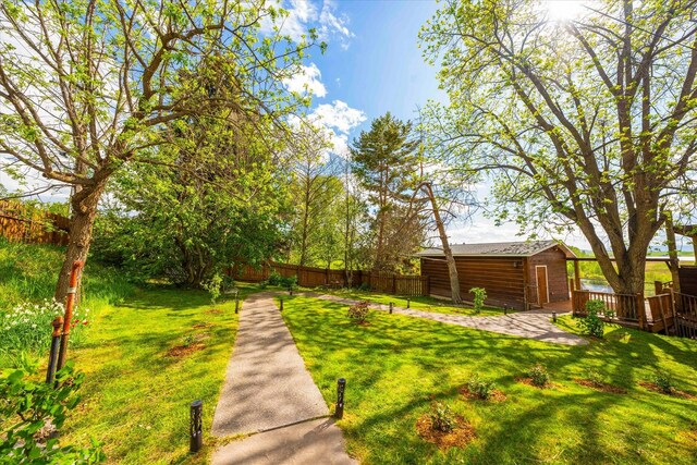 rear view of house with a wooden deck and a yard