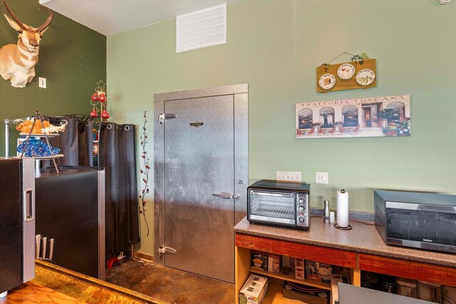 dining room featuring carpet, ceiling fan, lofted ceiling, and wood walls