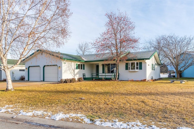 ranch-style home with a yard, covered porch, and a garage