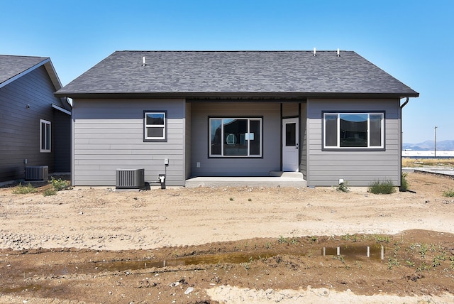 rear view of property with central AC unit