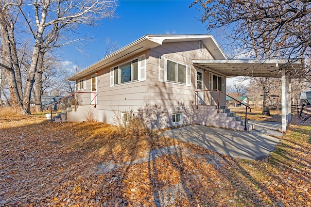 view of property exterior featuring a carport