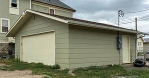 view of property exterior with a garage and an outdoor structure