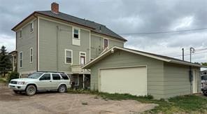 view of side of home with an outdoor structure and a garage